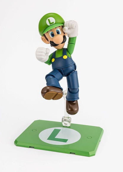 Toysverse TCG Bandai S.H. Figuarts Luigi action figure jumping on a green L-branded display stand